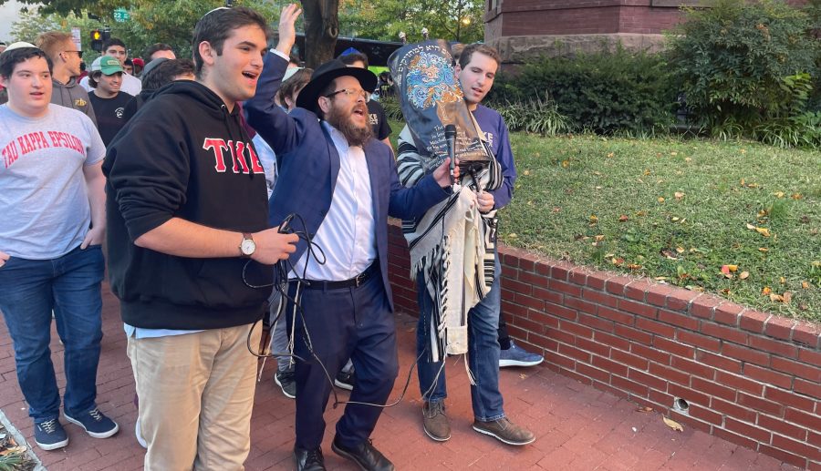 Rabbi Yudi Steiner leads George Washington University students in song and dance as they mark the destruction of an imitation Torah in a frat house in Washington DC, Nov. 1, 2021. (Ron Kampeas)