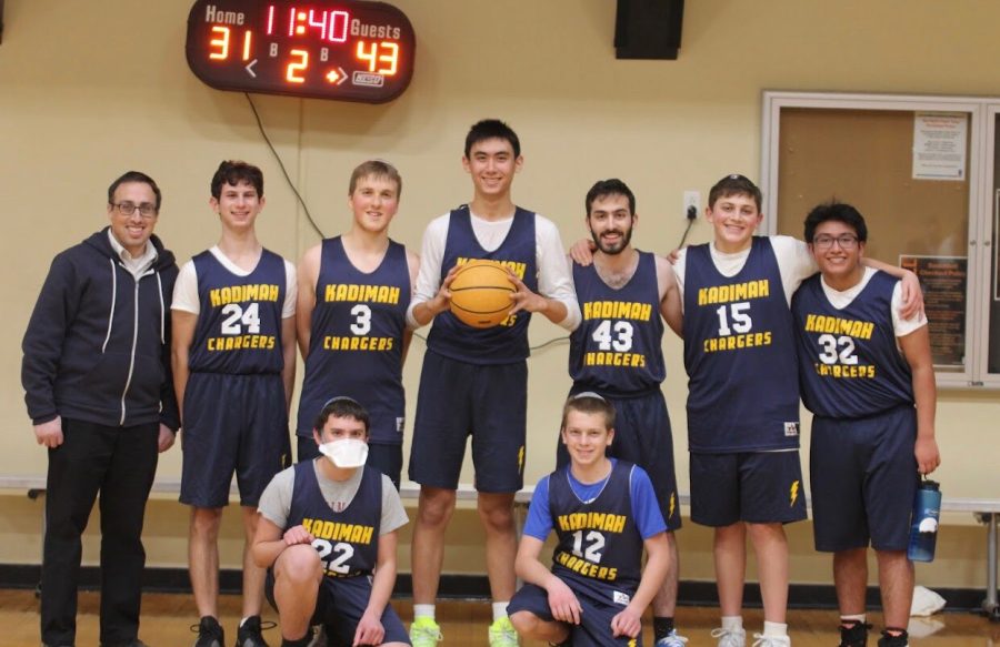 Mirowitz eighth grader Jacob Genin (center) stands with his Yeshivat Kadimah High School basketball teammates.