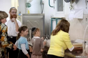 Rabbi Moshe Krivitski, pictured here with his wife, Miriam, and two of their four children at the Colel Chabad soup kitchen he ran in Beersheva, was among the four victims of a stabbing and car-ramming attack in Israel on March 22.