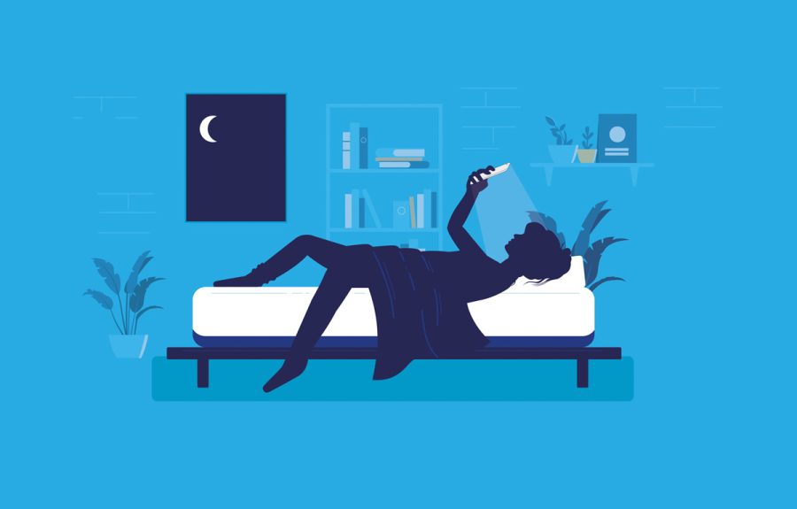 Woman lying awake in bedroom at night using her phone. Smartphon