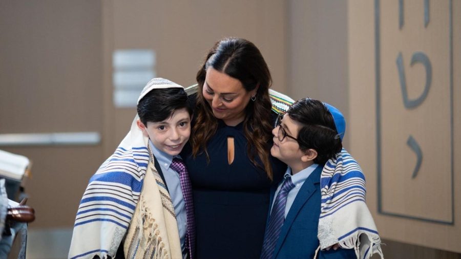 The Abeles family wrapped in Elis tallit that he wore on his bar mitzvah 30+ years ago. Photo: Spoonful of Sugar Photography
