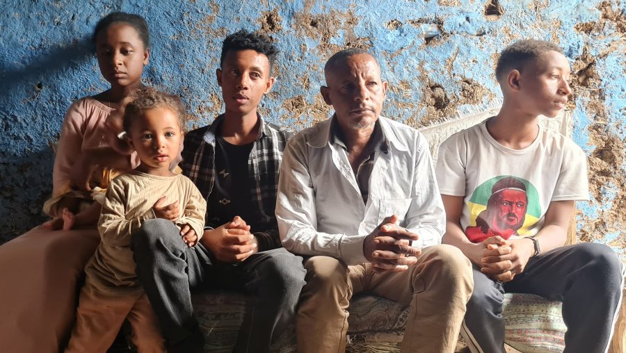 Kefale Tayachew Damtie, second from right, and his children greet visitiors to their home in Gondar, Ethiopia, May 29, 2022. (Cnaan Liphshiz)