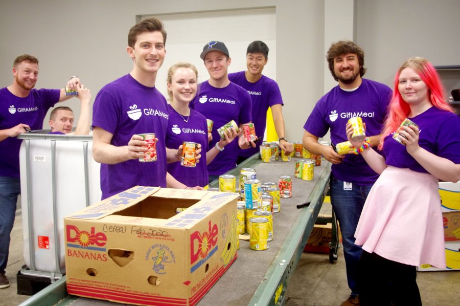 GiftAMeal staffers, including CEO Andrew Glantz (third from left) volunteer at a food bank.
