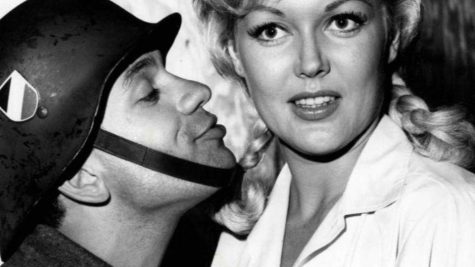 Robert Clary as Lebeau and Cynthia Lynn as Fräulein Helga from the television program Hogans Heroes, 1965. Source: Wikimedia Commons.

