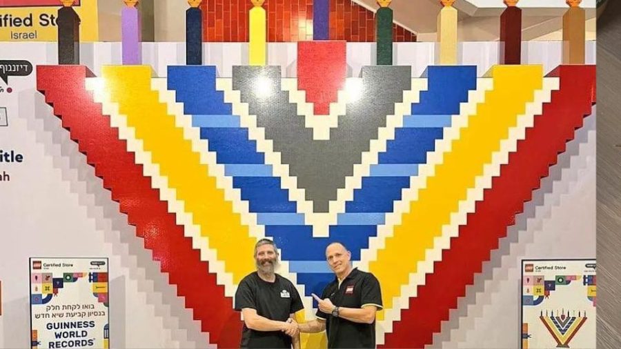 The massive LEGO menorah with Yitzchok Kasowitz (left), founder of Jbrick, and the manager of LEGO Store Tel Aviv. Source: Courtesy of Yitzchok Kasowitz.
