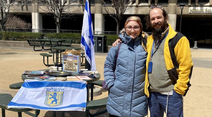 Rabbi Alexander Popivker (right) with his wife, Sarah, mounting a pro-Israel display on the campus of Cleveland State University. (Courtesy of Alex Popivker)