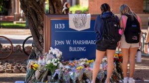 Students visit a makeshift memorial outside the John W. Harshbarger Building.Chris Richards/University of Arizona