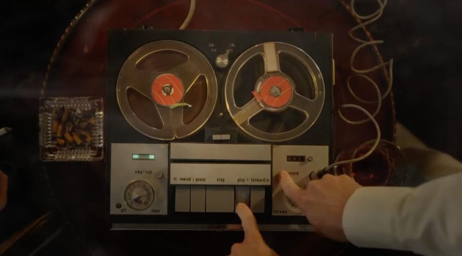 In a scene from The Devils Confession, someone sets up the recorder to listen to a tape. (Screenshot via YouTube)