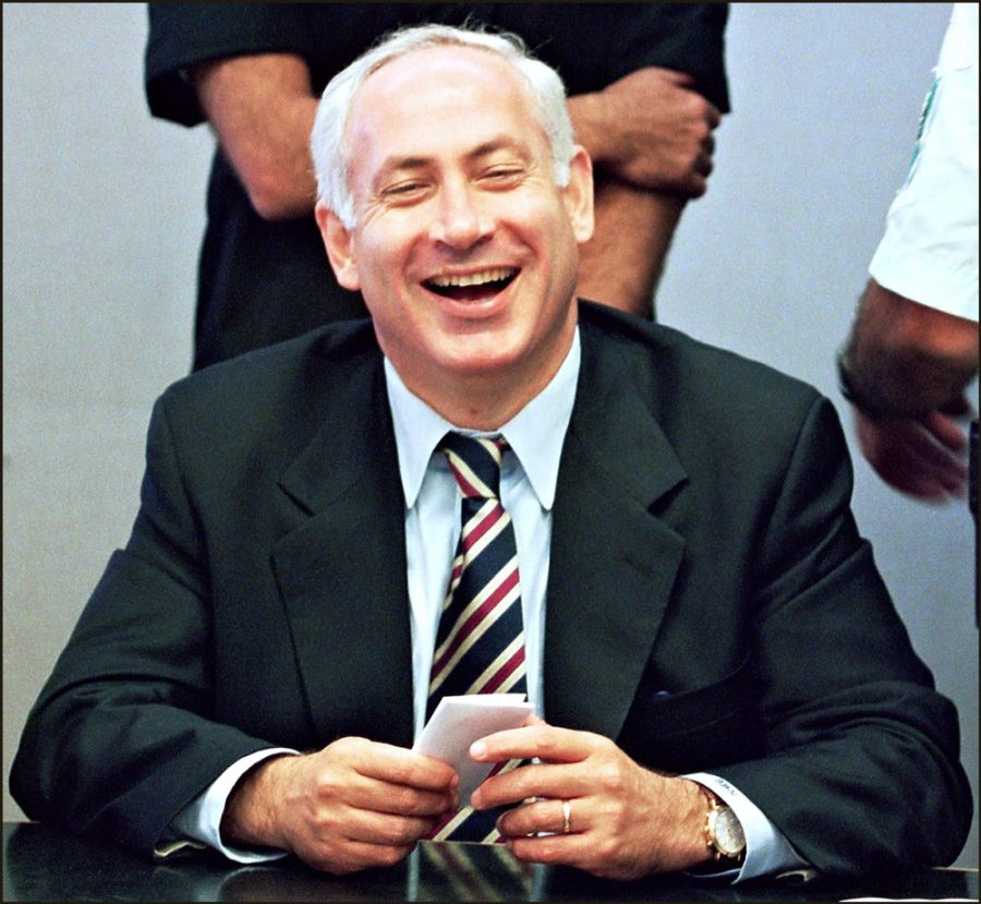 Prime Minister-elect Benjamin Netanyahu laughs 05 June 1996 in Jerusalem during Likud party meeting, to discuss the new coalition government. (Photo credit should read MENAHEM KAHANA/AFP via Getty Images)