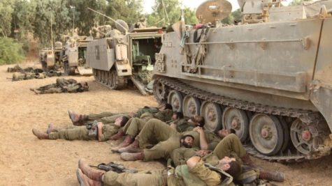 IDF reservists sleep near armored personnel carriers at the Gaza border, on the eighth day of Operation Protective Edge, July 15, 2014. Photo by Yossi Aloni/Flash90.