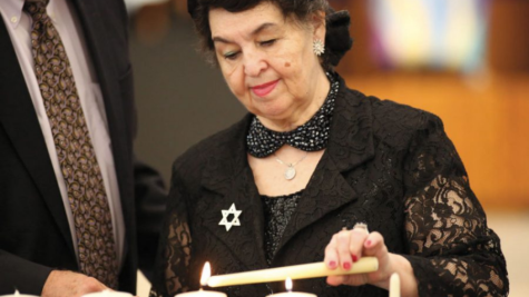 Holocaust survivor Larisa Graypel lights a candle of remembrance at the 2019 Yom HaShoah Community Commemoration organized by the Holocaust Museum and Learning Center of St. Louis and held at Congregation Shaare Emeth.  