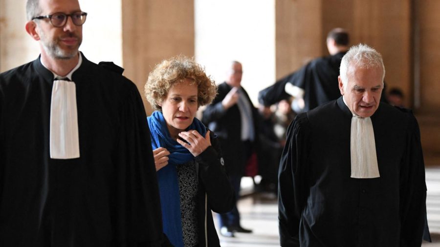 Corinne Adler, a victim who was 13 at the time of the Rue Copernic synagogue bombing, shown with lawyers at the Palais de Justice courthouse in Paris, April 3, 2023. (Bertrand Guay/AFP via Getty Images)