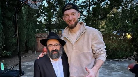 Rabbi Mendy Cohen is dwarfed by 7-foot-1 Kings center Domantas Sabonis, who attended Chabad of Sacramentos Purim party on March 7. (Courtesy of Chabad of Sacramento)