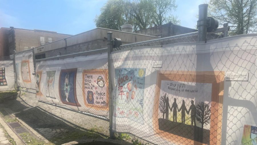The Tree of Life synagogue is surrounded by a chain link fence draped with paintings from schools around the country, in Pittsburgh, April 21, 2023. (Ron Kampeas)