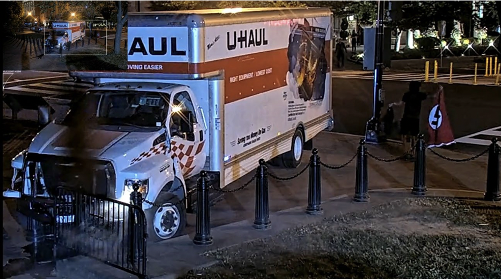 Figure 8, showing the Defendant exiting the U-Haul with his Nazi Flag. 