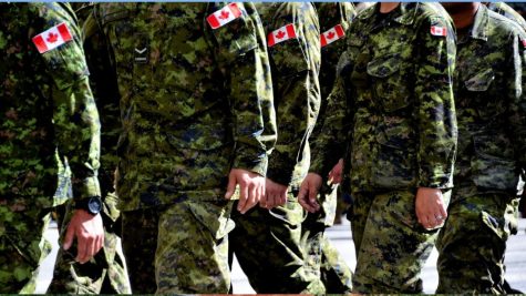 Canadian soldiers march in uniform.