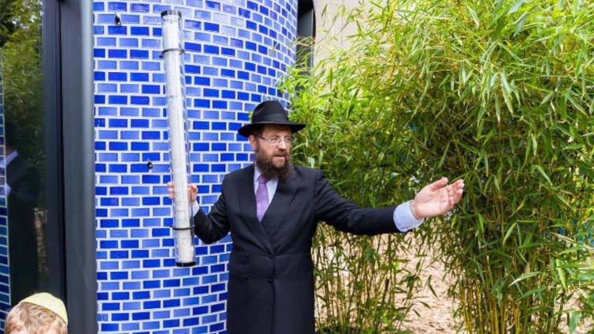 Rabbi+Yehudah+Teichtal+prepares+to+affix+the+massive+new+mezuzah%2C+one+of+the+worlds+largest%2C+at+the+Pears+Jewish+Campus%2C+a+sprawling+%2444+million+new+home+to+Chabad-Lubavitch+of+Berlin.