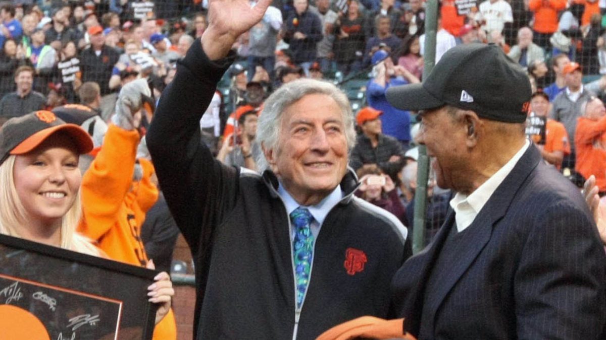 Aug 19, 2016; San Francisco, CA, USA; San Francisco Giants celebrated singer Tony Bennett 90th birthday which took place earlier in the week with a copy of the new game winning flag named after his hit song " I left My Hart in San Francisco" with Hall of Famer Willie Mays center and Larry Baer right CEO of the Giants at AT&T Park Mandatory Credit: Lance Iversen-USA TODAY Sports