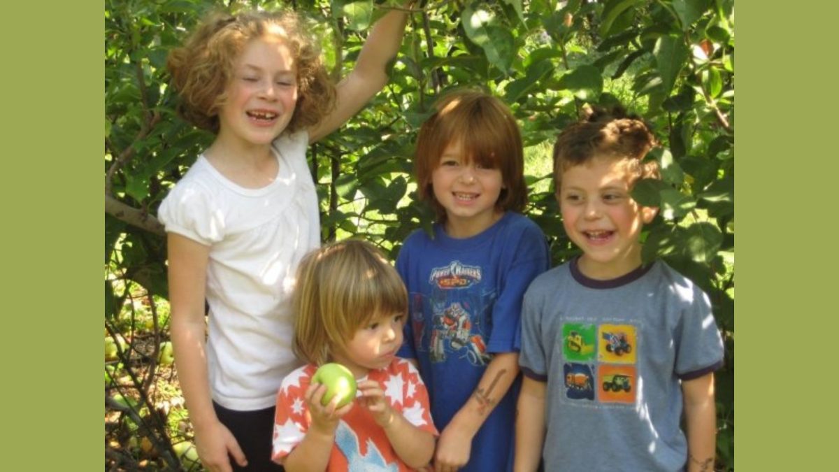 Mallory Palmer, Ingmar Glickma, Dustin Glickman and Max Palmer in the Eckert's apple orchard in 2008.