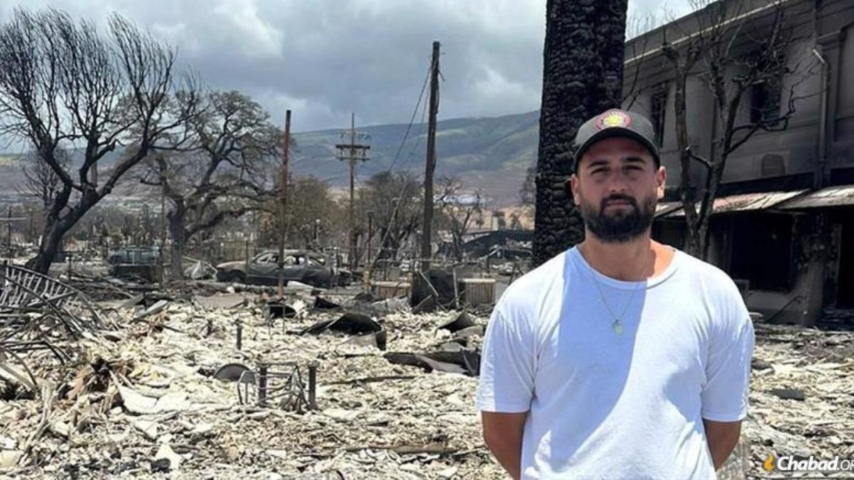 do Sarfati stands beside the burned out remains of his businesses in the town Lahaina on the island of Maui, Hawaii.