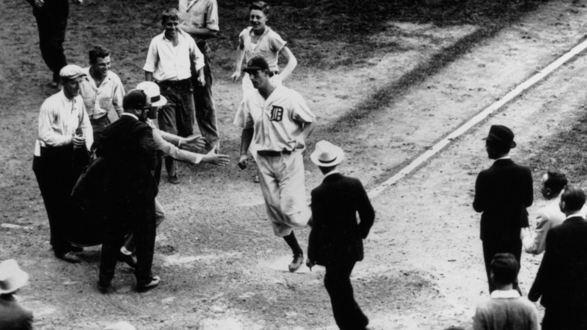 Hank Greenberg scores after hitting a home run to give the Detroit Tigers a 2-1 victory over the Boston Red Sox, Sept. 10, 1934. 