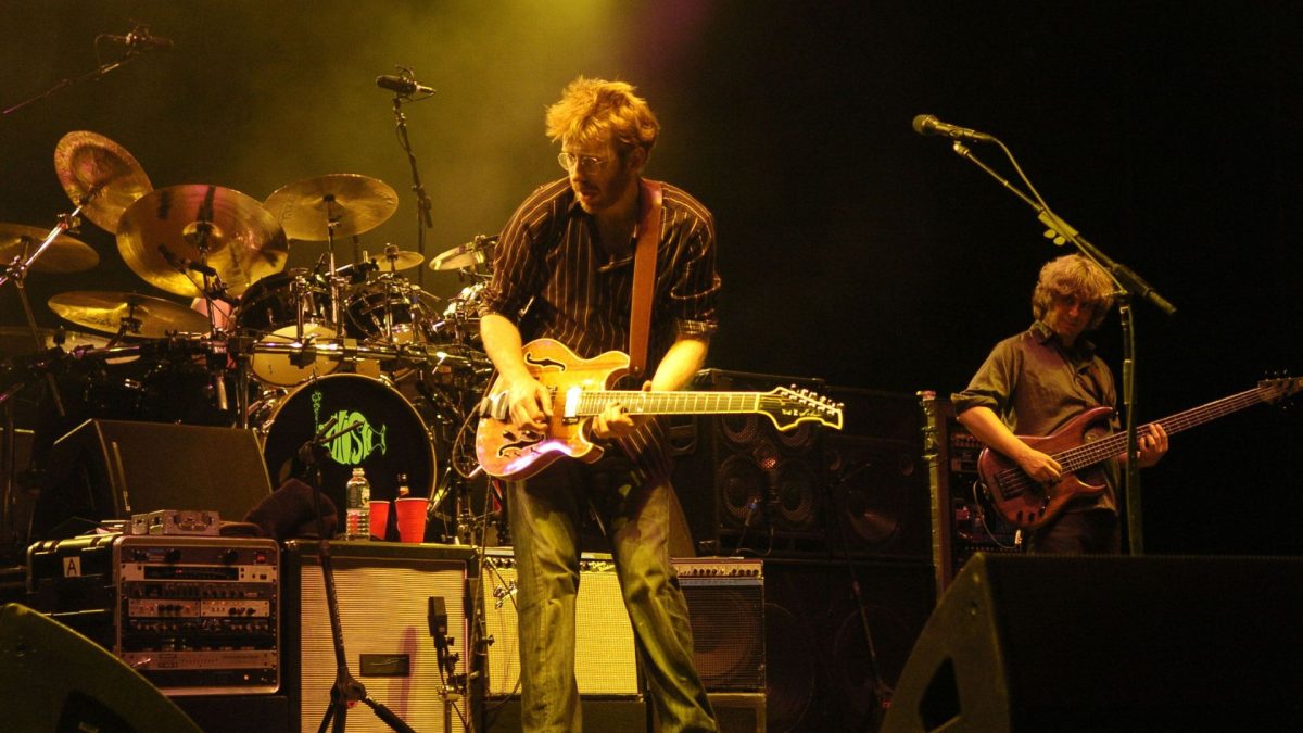Phish, shown performing in 2004, have cultivated a following that tracks them with religious fervor.
