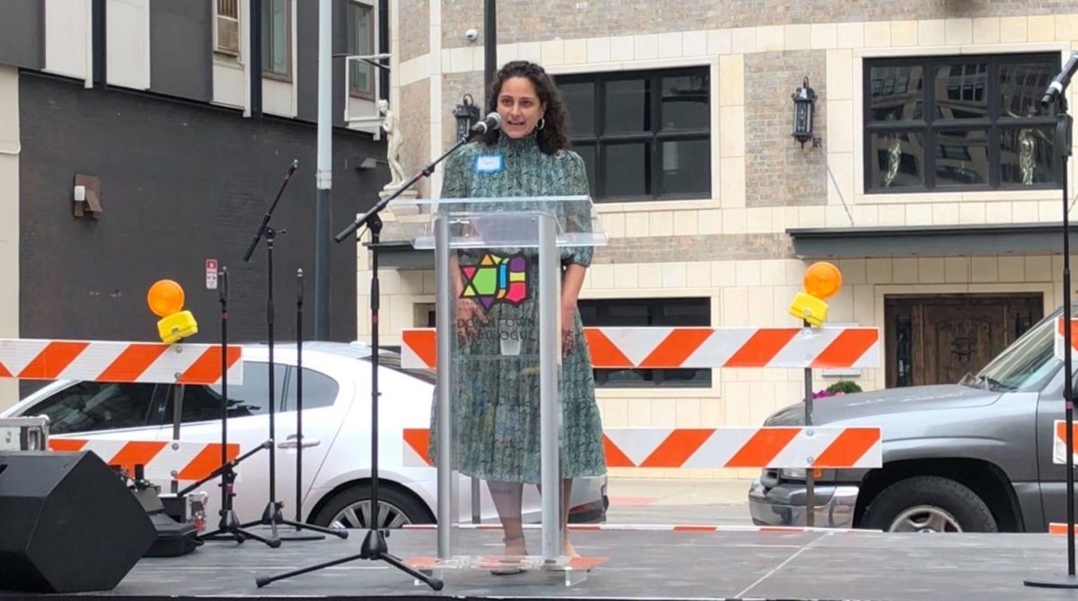 Samantha Woll, president of the Isaac Agree Downtown Synagogue in Detroit, welcomes attendees to the congregation’s centennial celebration and groundbreaking on a major renovation project, Aug. 14, 2022. 