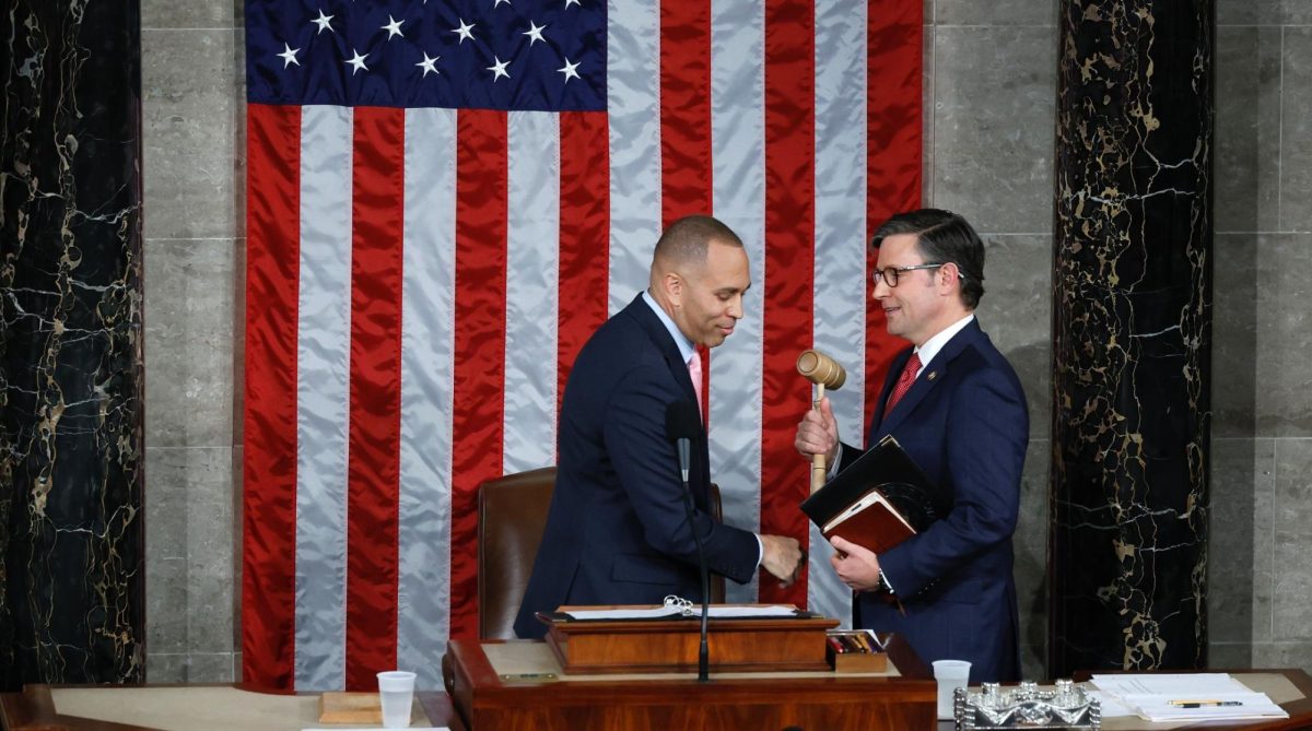 U.S. House Minority Leader Hakeem Jeffries, a New York Democrat, on the left, hands the gavel to newly elected Speaker of the House Mike Johnson, a Louisiana Republican, after the House of Representatives held an election in the U.S. Capitol, Oct. 25, 2023. 