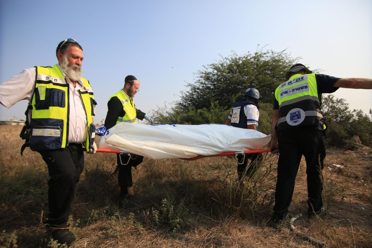 Medical responders carry a body bag in Sderot, Israel, Oct. 8, 2023. (Saeed Qaq/Anadolu Agency via Getty Images)