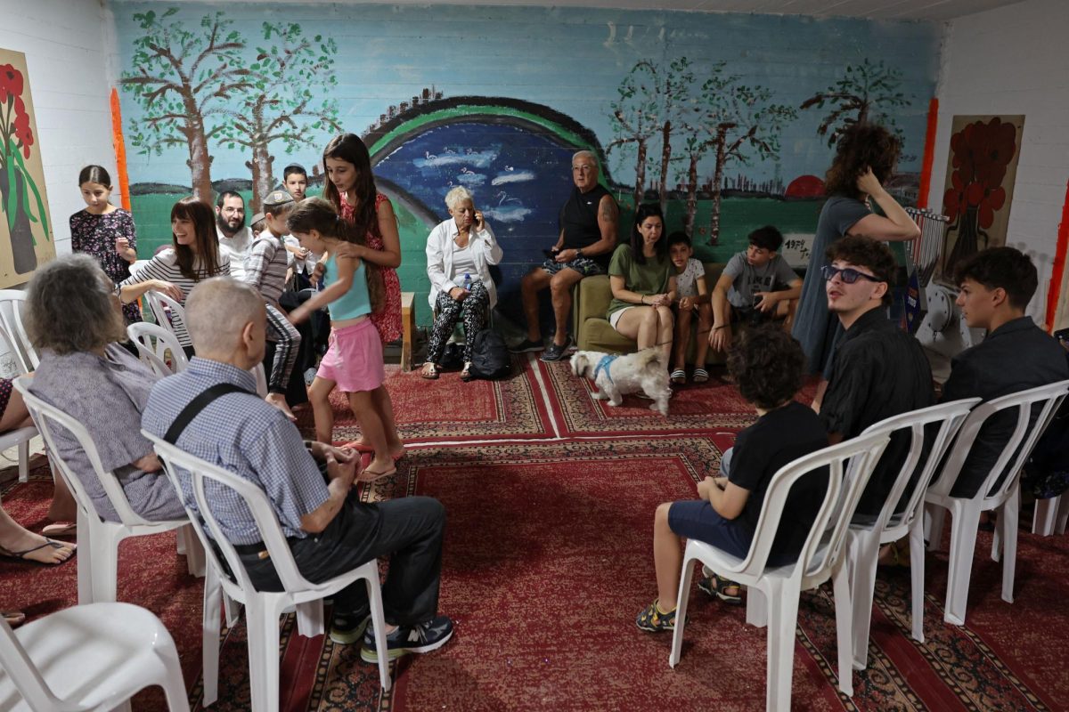 Residents take shelter in the basement of a Tel Aviv building following a rocket attack from the Gaza Strip into Israel on Oct. 7, 2023. (Jack Guez/AFP via Getty Images)