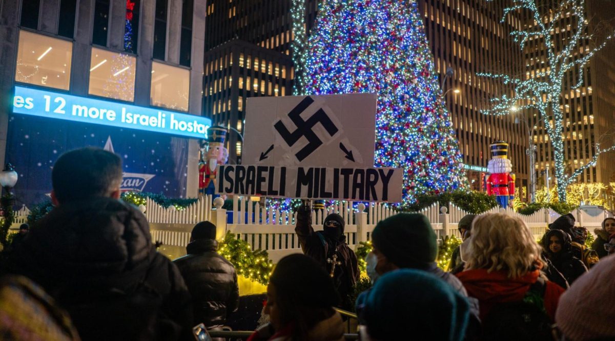 A pro-Palestinian protests against the Rockefeller Christmas tree lighting, in New York City, November 29, 2023. 