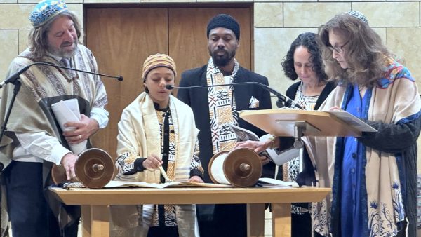 Dor Tsadik Osher chants from the Torah as his parents Shemohn and Khaya watch, Nov. 18, 2023. 