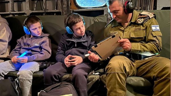 An Israeli soldier talks with Tal, 9, and Gal Goldstein, 11, of Kfar Aza, on their way back to Israel from Hamas captivity, Nov. 26, 2023. 