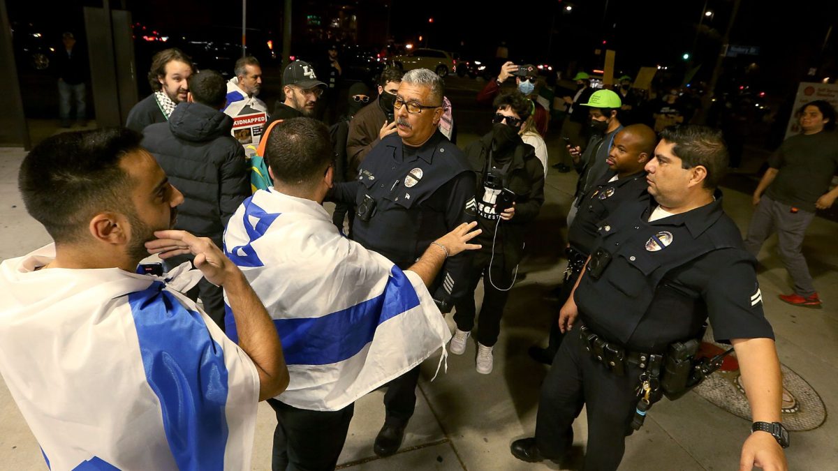 LAPD officers get between pro-Israel and pro-Palestinian activists outside The Museum of Tolerance in Los Angeles on Wednesday, Nov. 8, 2023. The museum held a private screening of footage documenting the Hamas invasion of Israel on Oct. 7th. Supporters of Palestine protested across the street outside. 