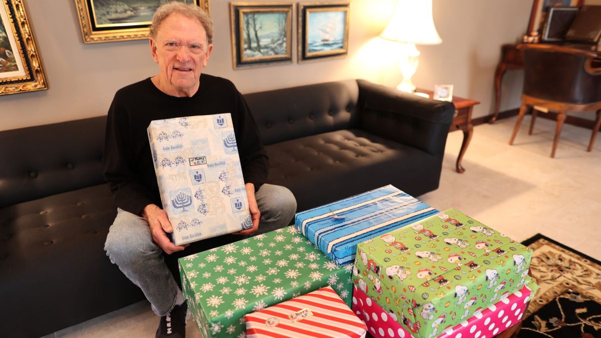 Harold Sanger shows the gifts accumulated during the year that ‘Hanukkah Joe’ will present him during the holiday. 