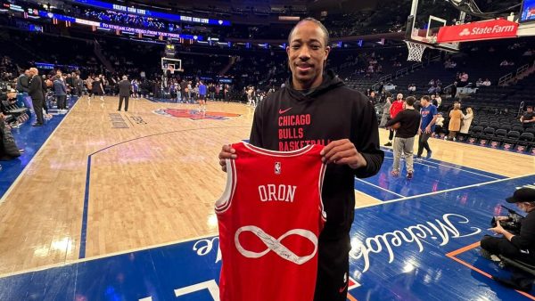 DeMar DeRozan displays the jersey he signed at Madison Square Garden. 