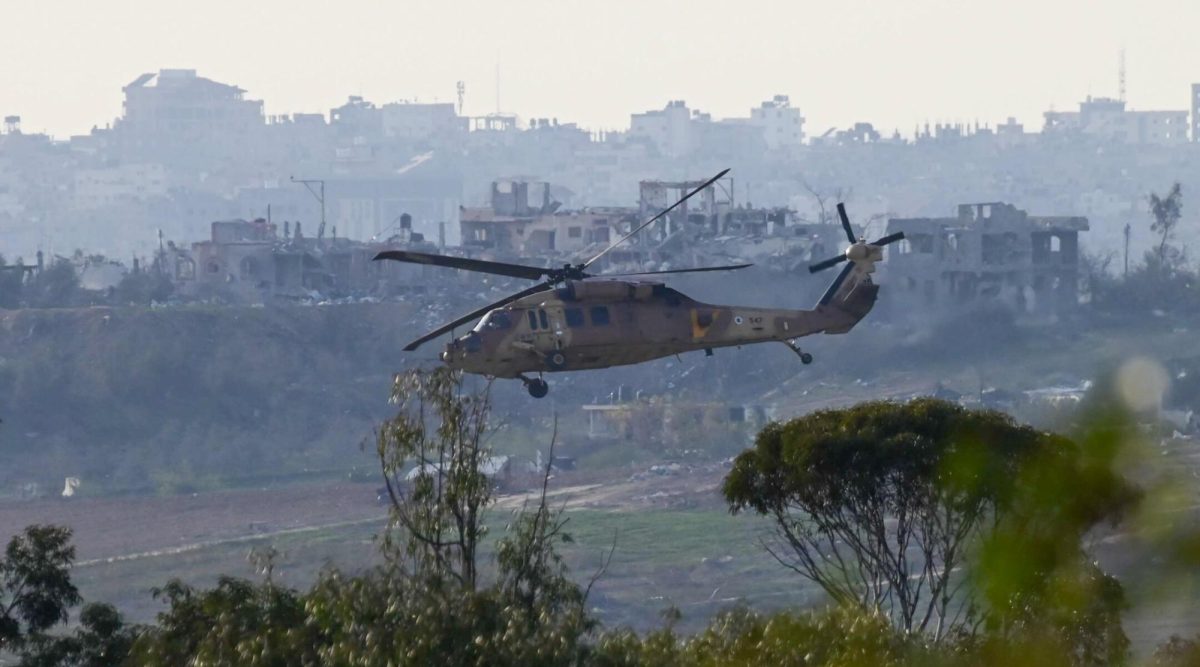A military helicopter flying above the Gaza Strip, as it seen from the Israeli side of the border, on Jan. 8, 2024. 