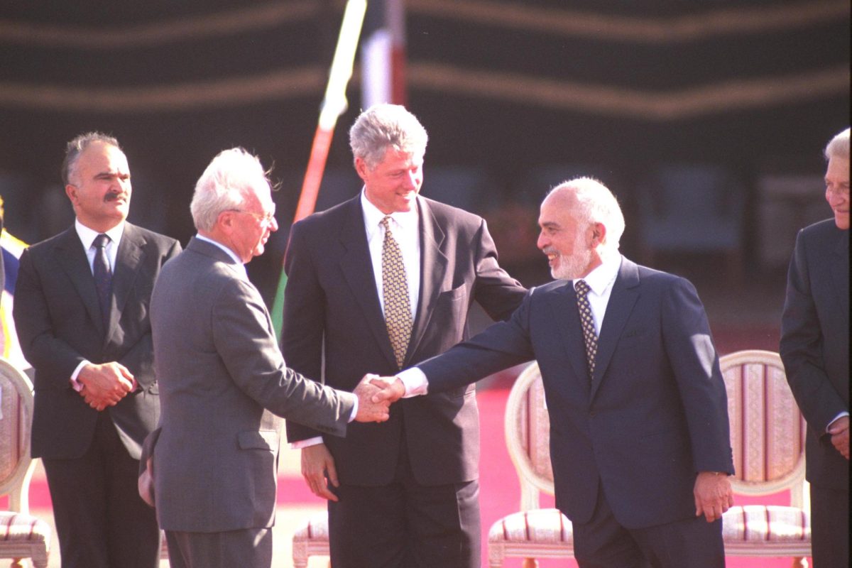 Israeli Prime Minister Yitzhak Rabin (left) and Jordan’s King Hussein shake hands in front of U.S. President Bill Clinton after signing their peace treaty Oct. 26, 1994, in the Arava. By Ya’acov Sa’ar, Israeli Government Press Office