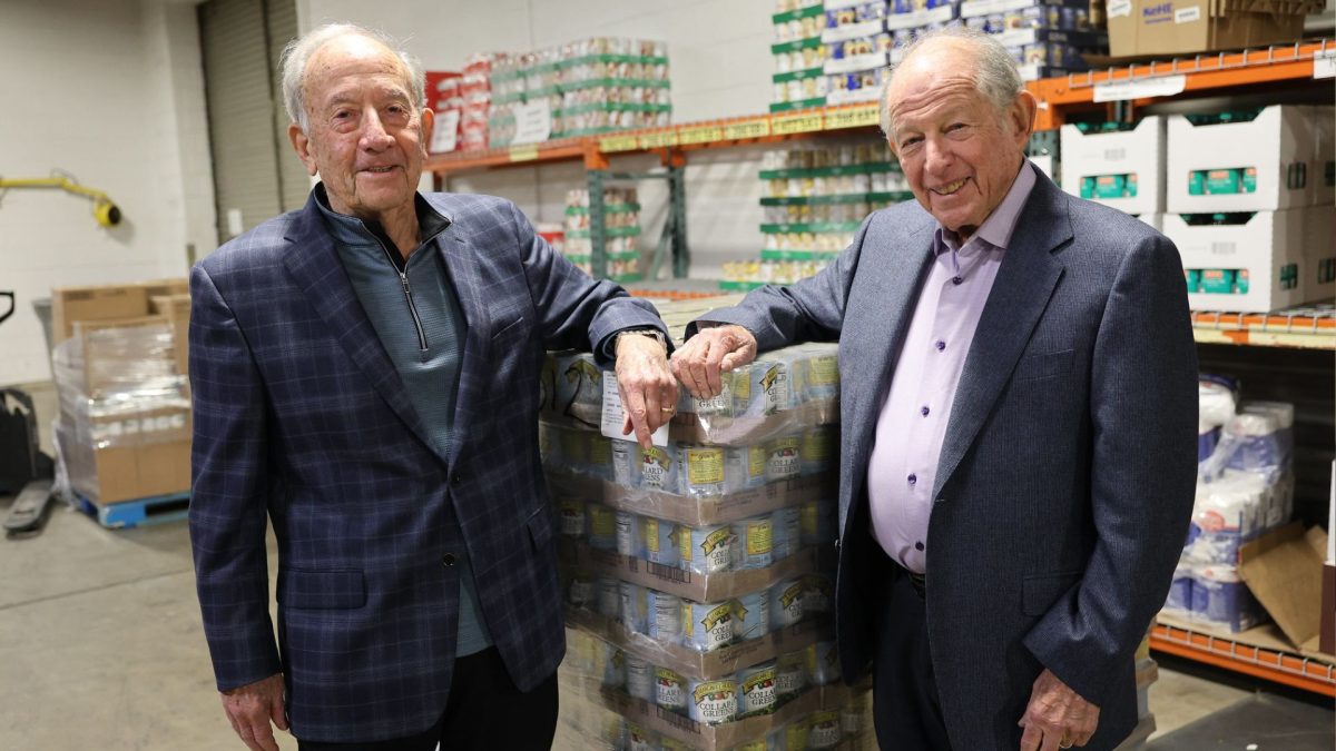 Earl Kessler and Al Siwak, the cofounders of Pallet Partners, are shown at the Harvey Kornblum Jewish Food Pantry. 