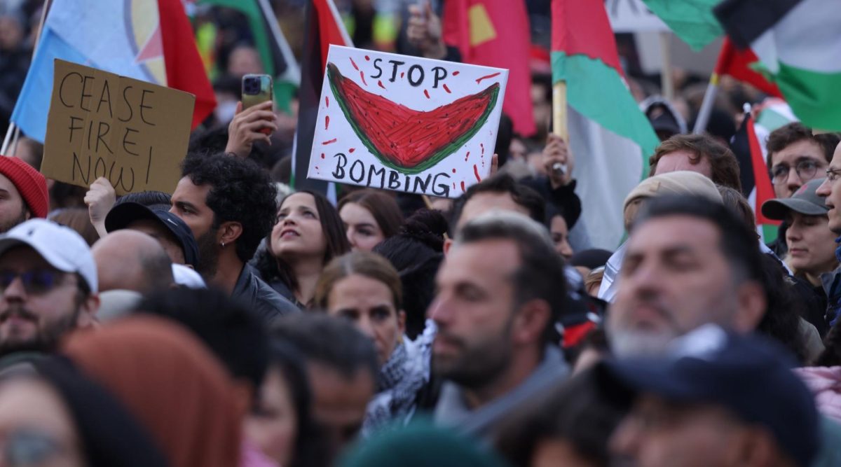 People wave Palestinian flags and hold a picture of a watermelon as they gather for a Global South United protest to demand freedom for Palestine in Berlin, Oct. 28, 2023. 