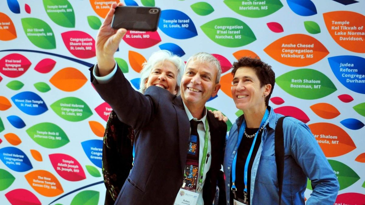 Participants at the Union for Reform Judaism’s 2019 convention in Chicago pose in front of a photo backdrop. The congregational arm of the Reform movement unveiled a new logo and visual brand earlier this month. 