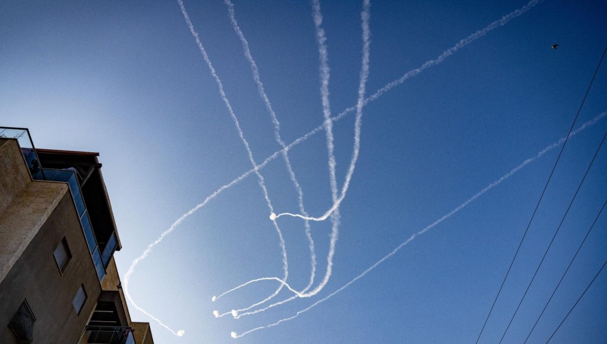 Contrails of Israeli Iron Dome anti-missile defense system strike Hamas rockets overhead as Hamas militants in Gaza continue fire into Israel, despite being targeted by more than 14,000 strikes during eight weeks of Israeli bombardment and a ground offensive, in Sderot, Israel, Dec. 4, 2023. (Scott Peterson/Getty Images)