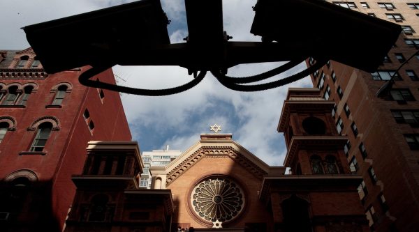 Security cameras hang across the street from the Park East Synagogue in New York City.