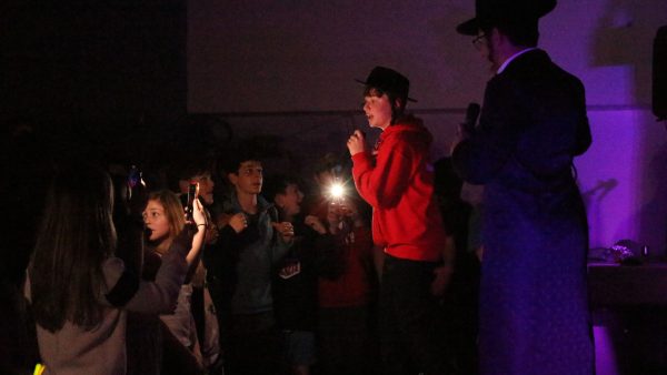 Lil’ Yiddy (aka Sam Shanker), an eighth-grade student at Epstein Hebrew Academy, raps during  a concert to benefit the school’s eighth-grade class trip. At right, is Sam’s ‘hype man’ Shai Fendelman.
