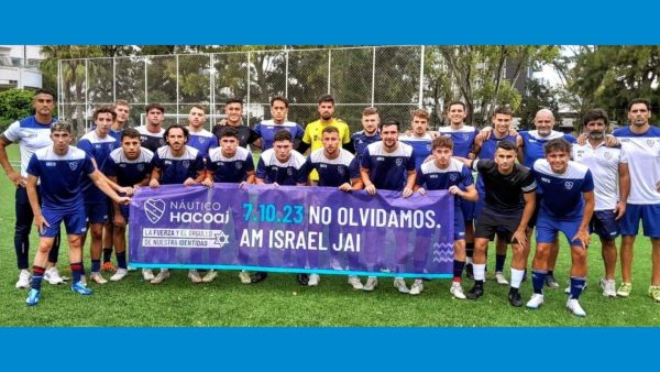 The Hacoaj team posing with a banner honoring Israel. (Courtesy)