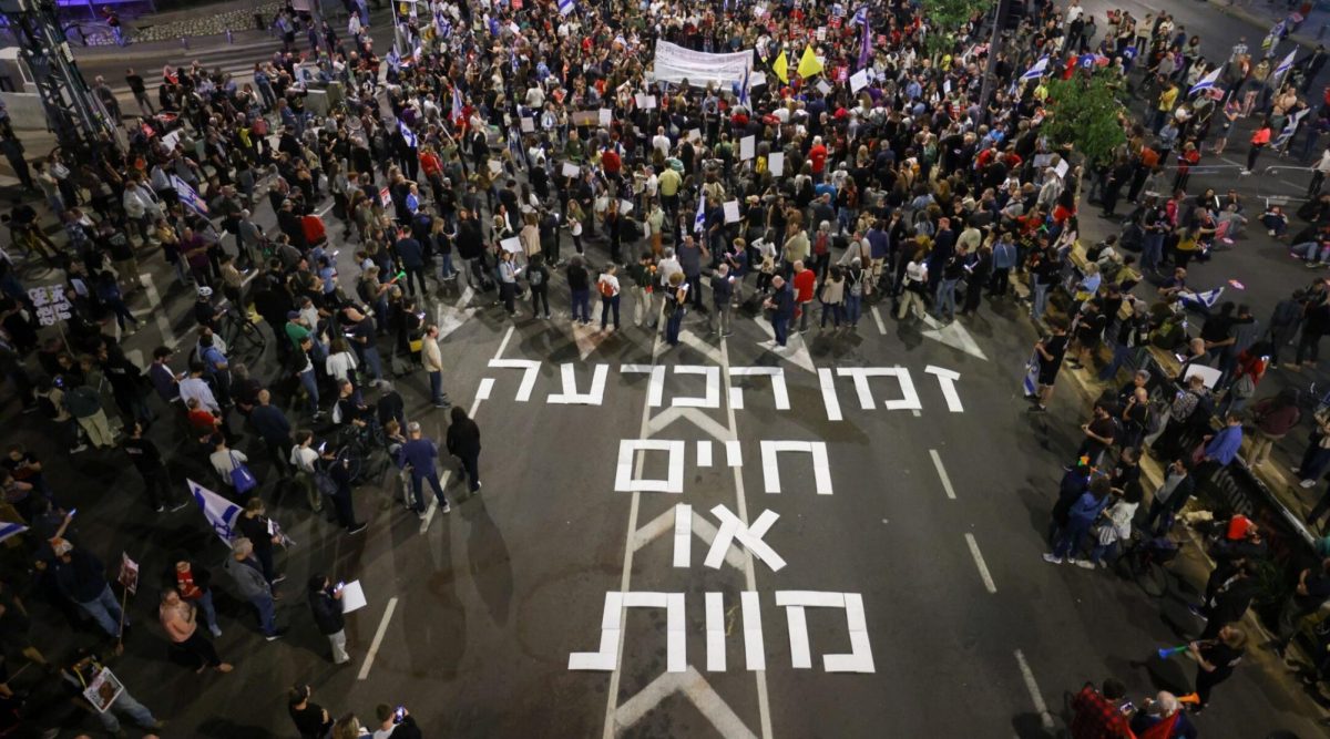 Spelling out the words, Decision time, life or death, demonstrators protest, calling for the release of Israeli hostages held in the Gaza Strip, outside Hakirya Base in Tel Aviv, May 6, 2024. (Chaim Goldberg/Flash90)