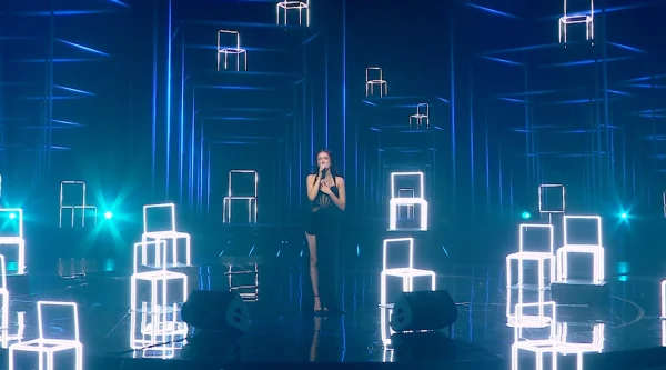 Eden Golan performs an emotional rendition of Aerosmiths I Dont Want to Miss a Thing, surrounded by empty chairs representing the missing hostages, for her grand finale performance to represent Israel in the 2024 Eurovision Song Contest. (Screenshot via Mako.co.il)