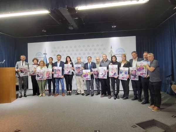 Lawmakers, Jewish leaders and others hold posters of the remaining Argentinean hostages in Israel during an event at parliament in Buenos Aires, May 7, 2024. (Juan Melamed)