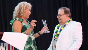 Ellen Futterman, president of the American Jewish Press Association, presents an award to outgoing president Alan Smason at the annual conference in New Orleans in July 2023. Photo by Bill Motchan.