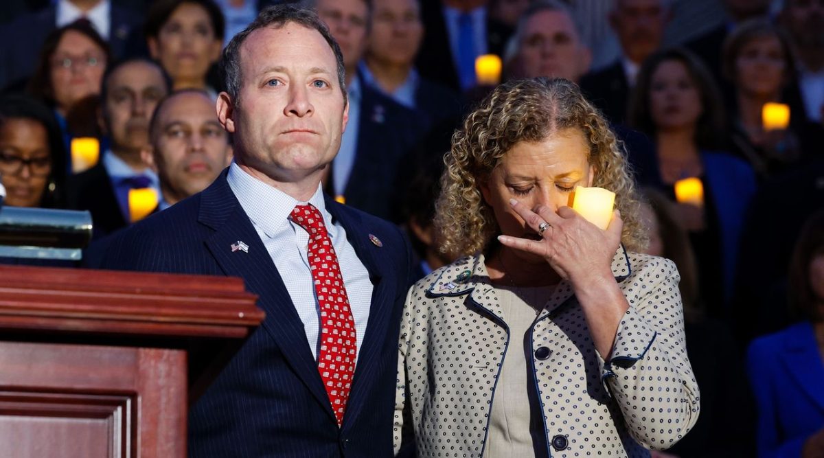 Rep. Josh Gottheimer, a New Jersey Democrat, and Rep. Debbie Wasserman Schultz, a Florida Democrat, listen as Margaret Grun Kibben, the chaplain of the U.S. House of Representatives, leads a prayer during a vigil for Israel on the steps of the U.S. Capitol Building, Oct. 12, 2023. 